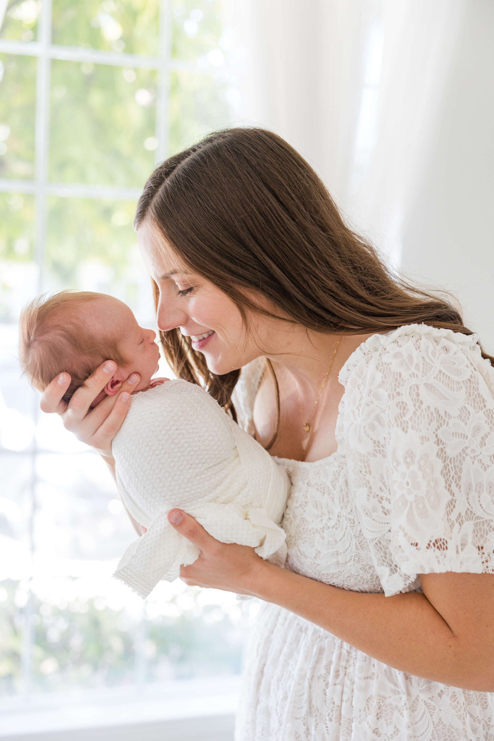 Newborn baby swaddled in neutral blanket during Sacramento studio session